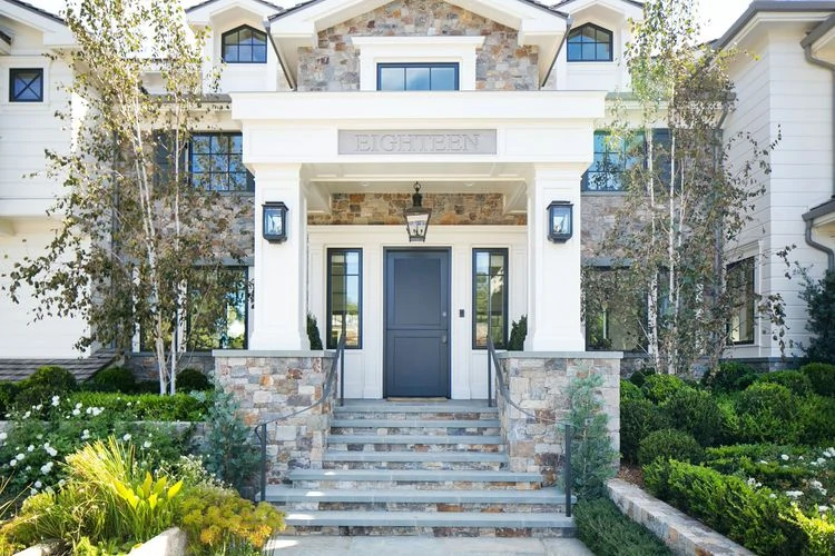 I love the elements of stone incorporated with the white walls and dark trim on this home.