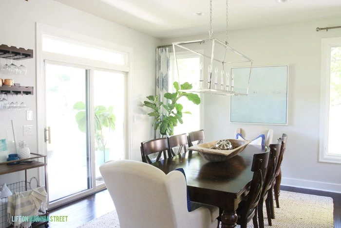 The Behr Silver Drop paint lightens up the Dining Room with a Darlana Linear Pendant Chandelier.