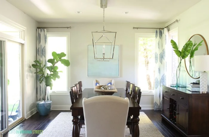 Formal shot of our elegant dining room with Behr Silver Drop walls and blue and white accents.