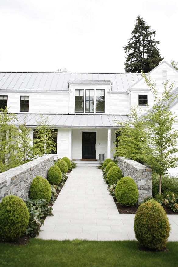 My exterior house plans are being informed by homes like this one with metal roofs, dark trim and a white exterior.