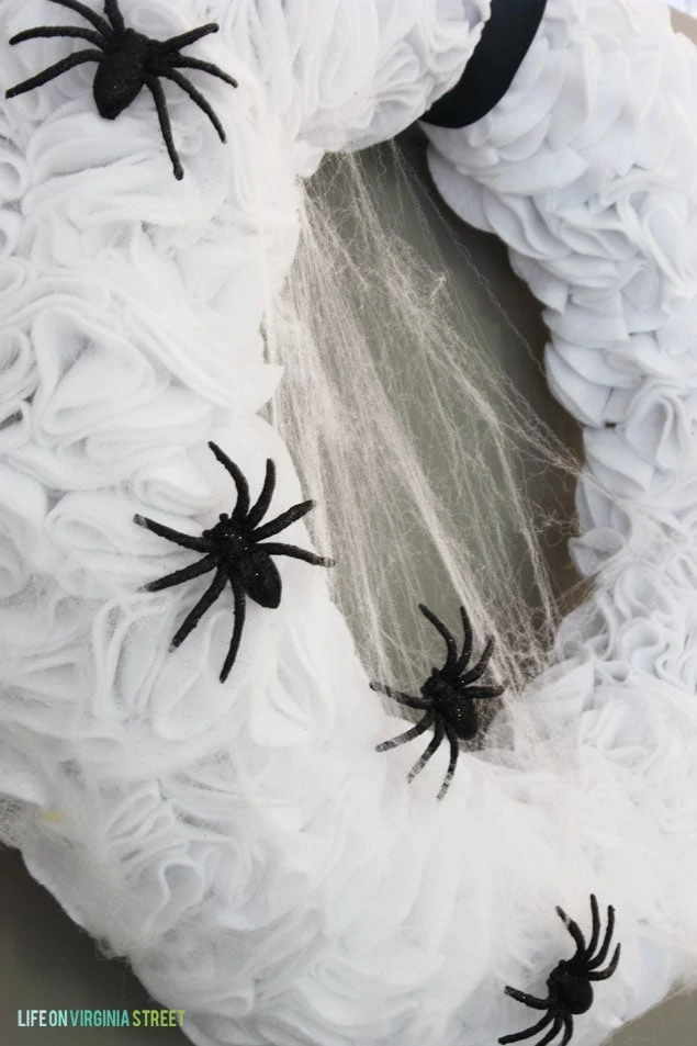 Cobwebs and black spiders on the ruffled wreath.