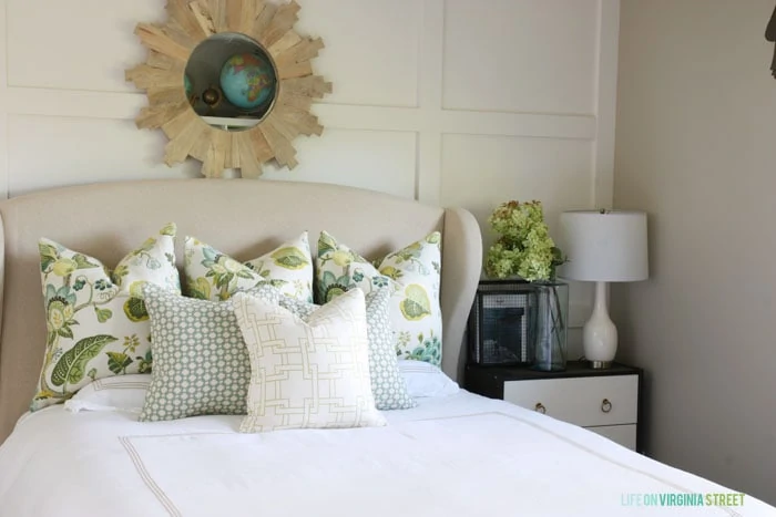 I love the green pillows--they're so fresh and inviting. They go perfectly with the sprig of hydrangeas on the nightstand. 
