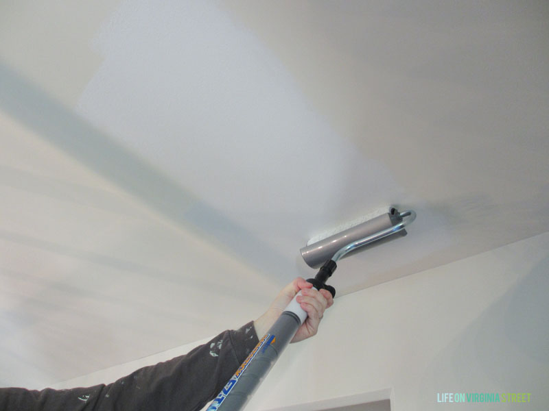 Using a long EZ roller on the ceiling.