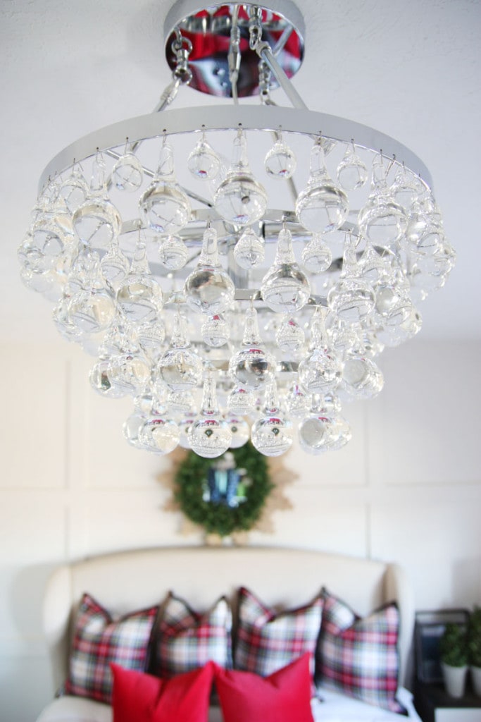 Guest bedroom glass chandelier in bedroom.