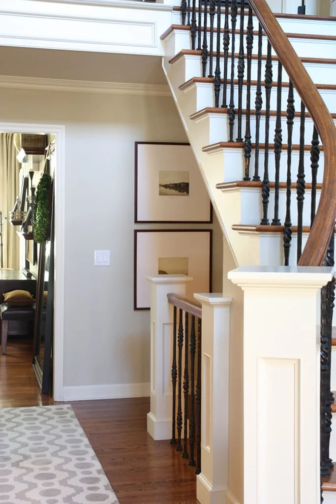 Entryway staircase with iron banisters and a beautiful neutral wall colors - Neutral Home Tour - Life On Virginia Street