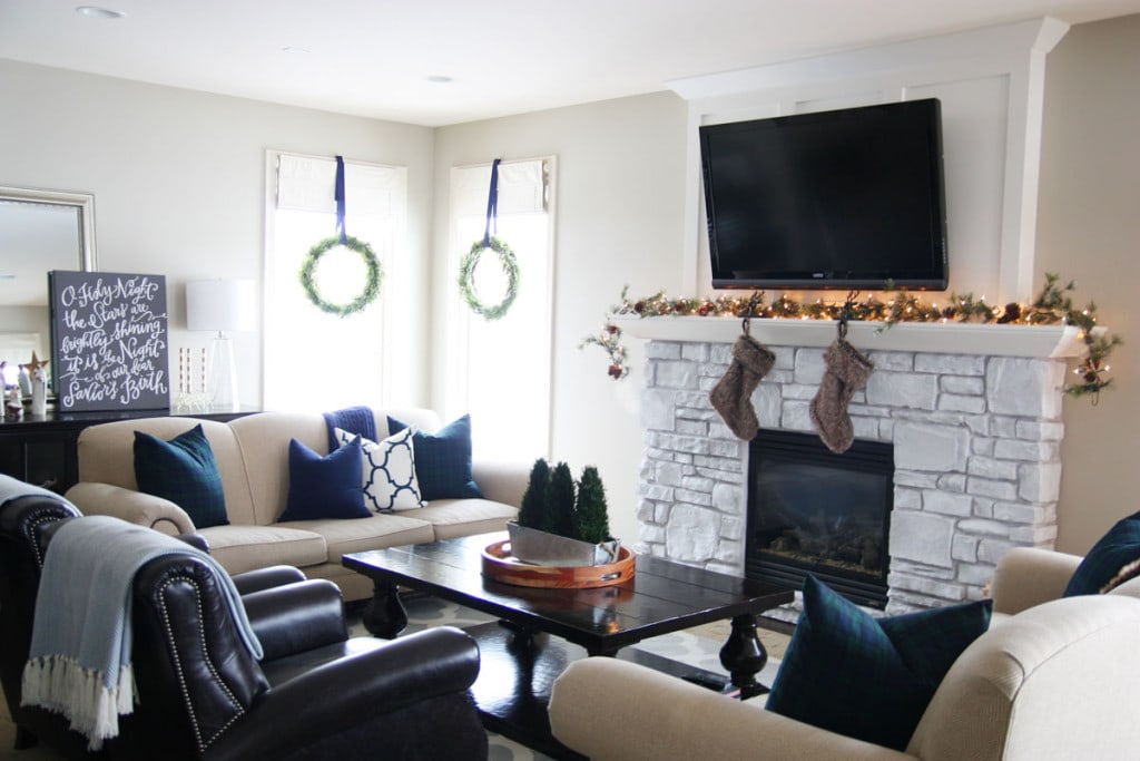 A Christmas living room with navy blue and hunter green decor.