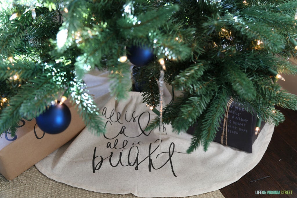 A darling tree skirt with handwritten "All is Calm, All is Bright" message.