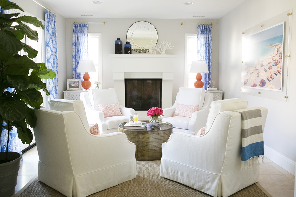 White armchairs around a round table.