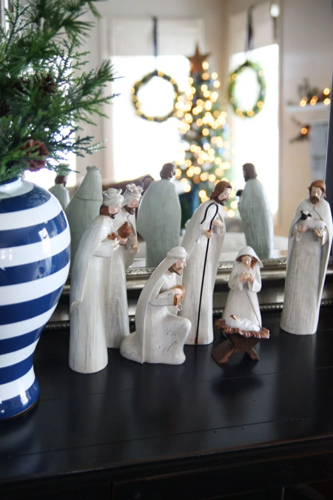 A wood nativity scene in a blue and white Christmas living room.
