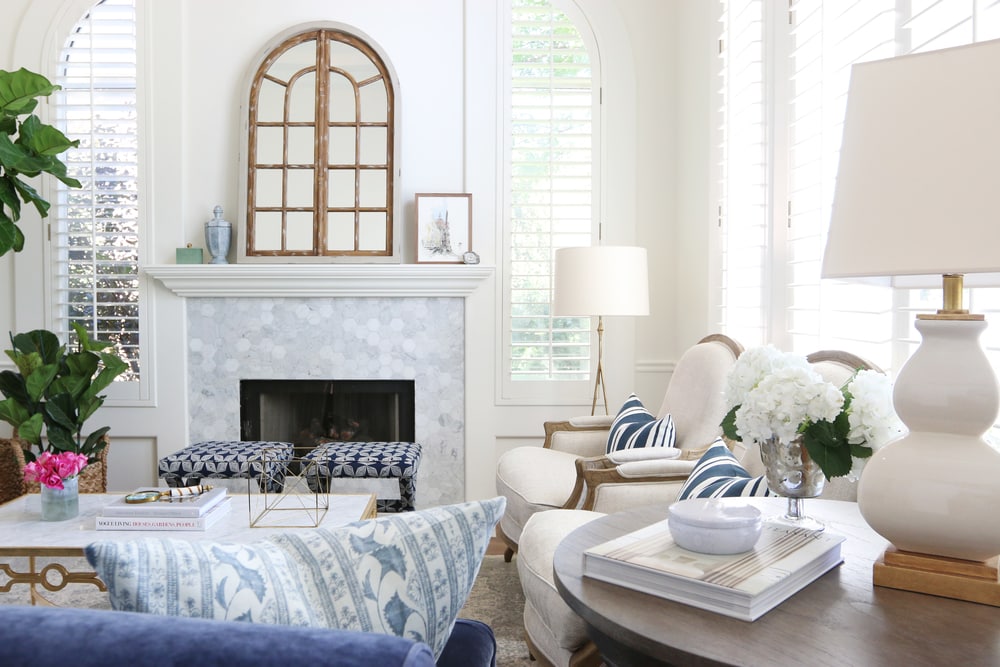 Navy White and Gray Living Room with pink flowers on table.