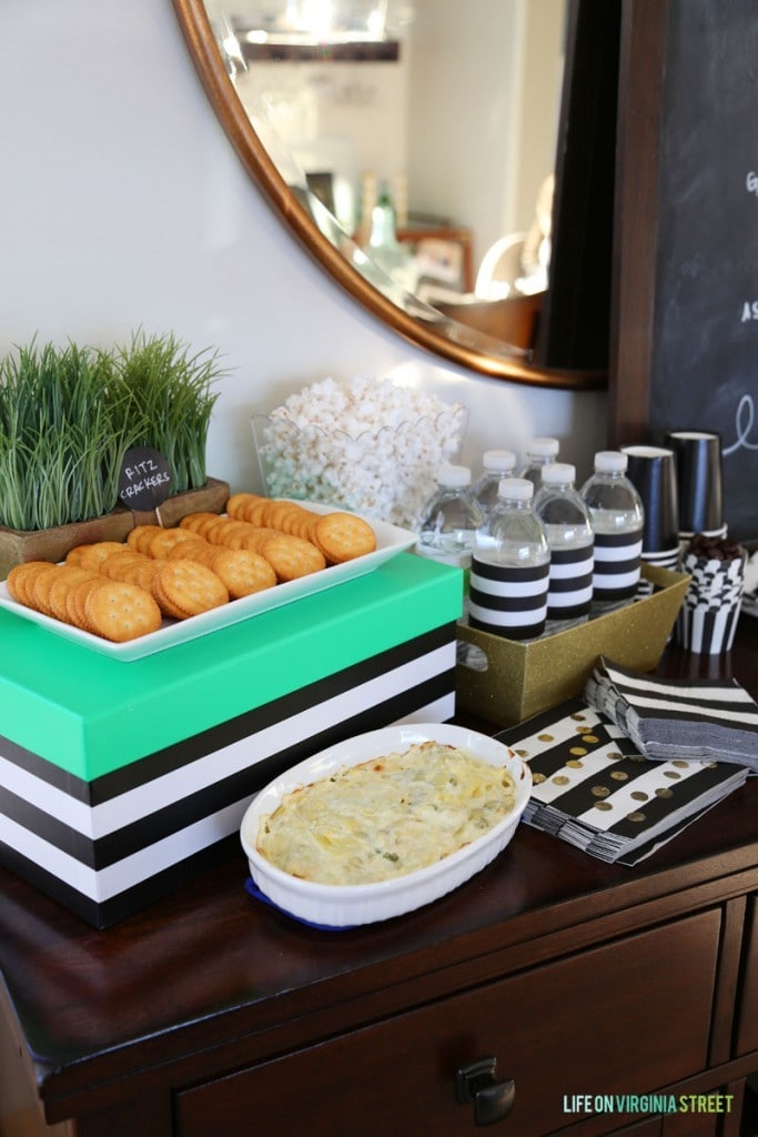 Cheesy Hot Artichoke Dip and Ritz Crackers on the table.