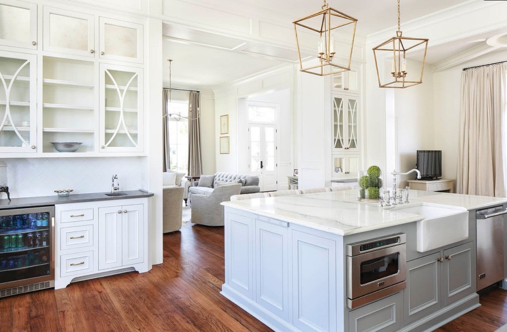 White Kitchen with Gold Darlana Pendants Over Island via Telich Custom Homes