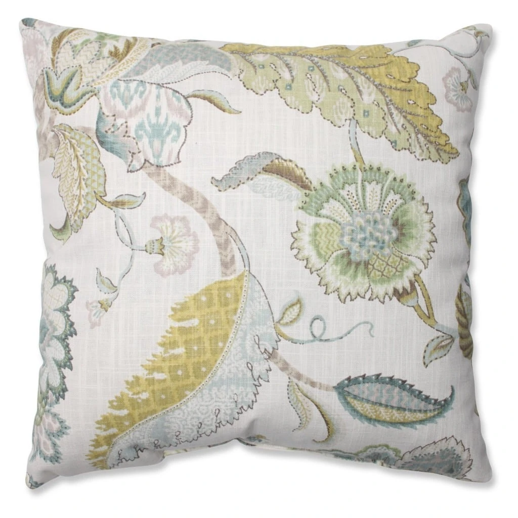 A floral pillow with soft green, yellow and blues.