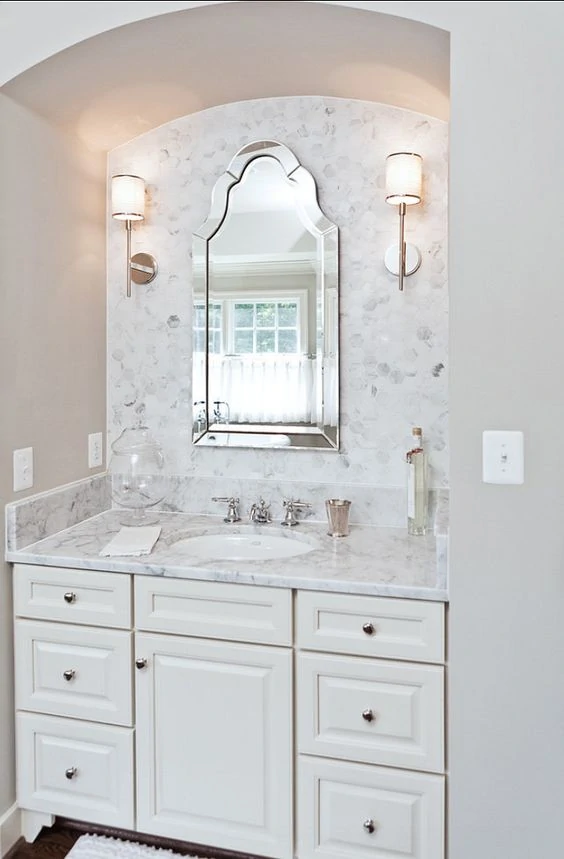 Powder Bath with Hex Marble Backsplash and White Cabinets via Homebunch