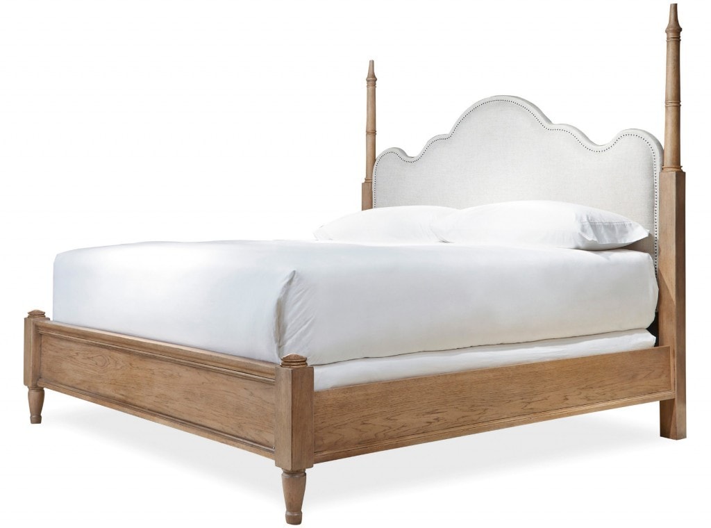 A poster bed with light wood and white bedding.