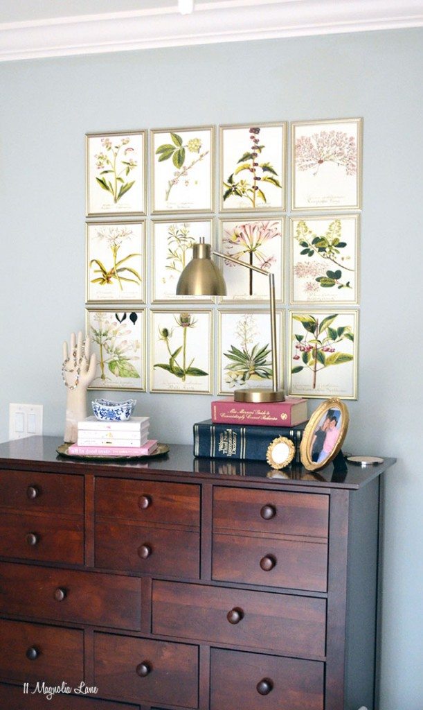 Floral pictures above a wooden dresser.
