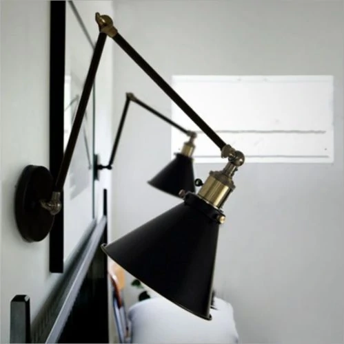 Industrial Swing Arm Sconce from eBay in black with brass details.