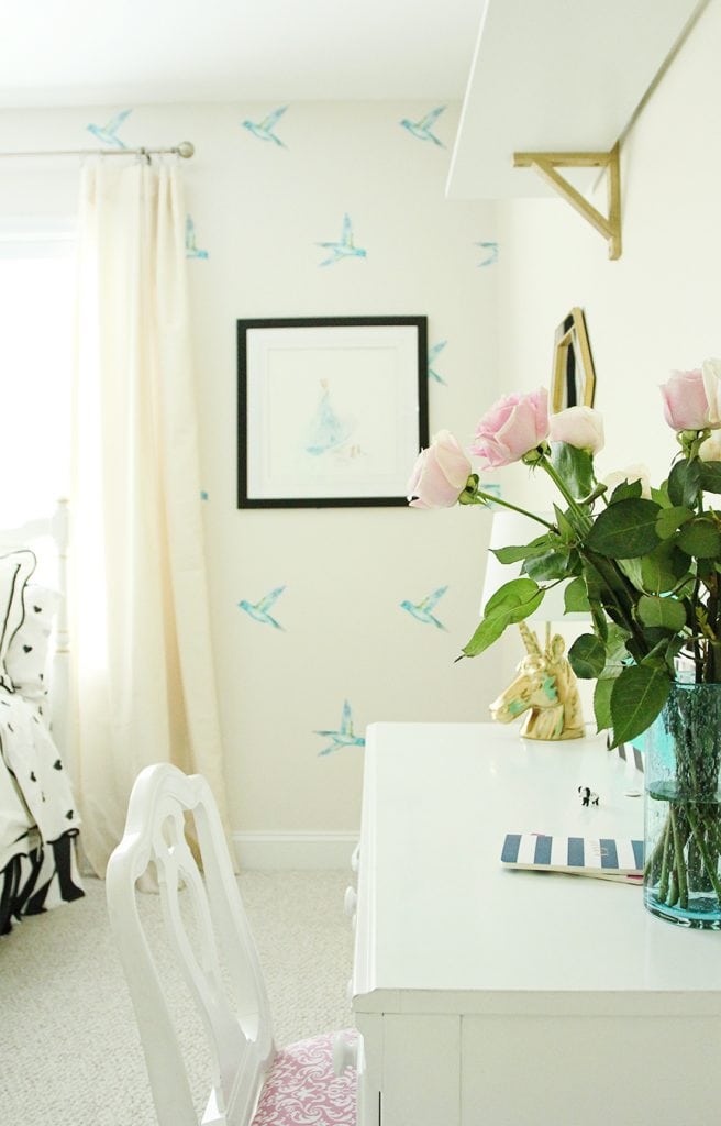 Disney wallpaper and Cinderella art on the wall in this girl inspired bedroom.