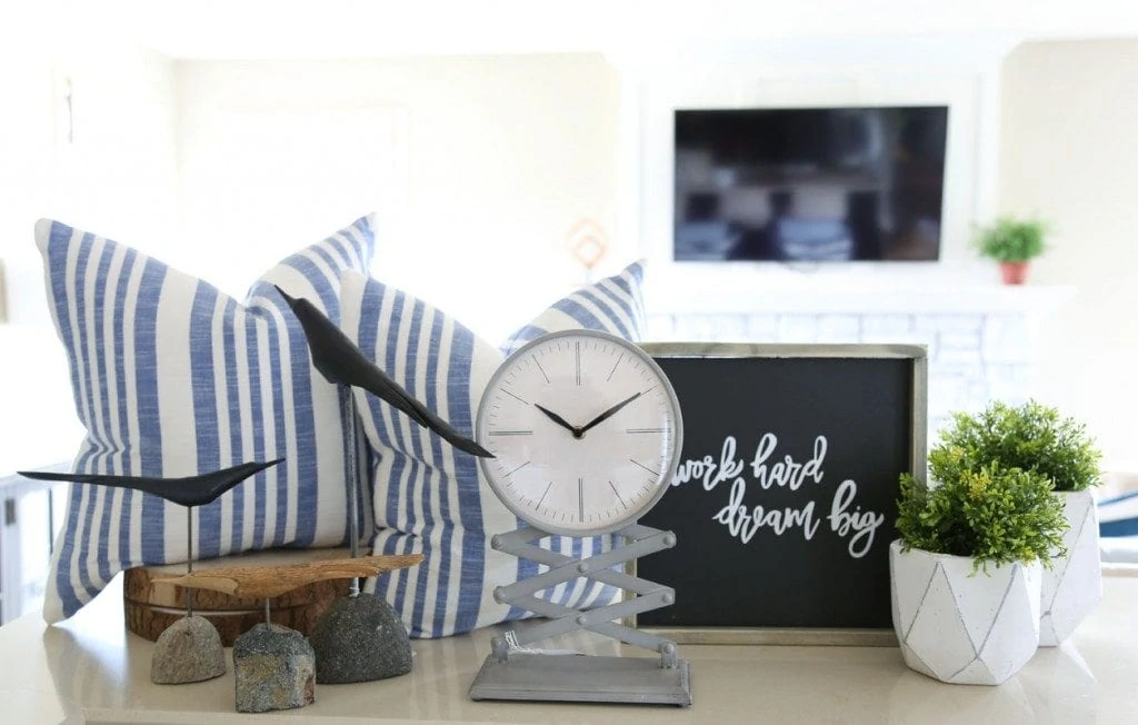 Love these home decor finds for spring: blue and white linen striped pillows, Work Hard Dream Big sign, concrete planters, painted metal clock and wood birds!