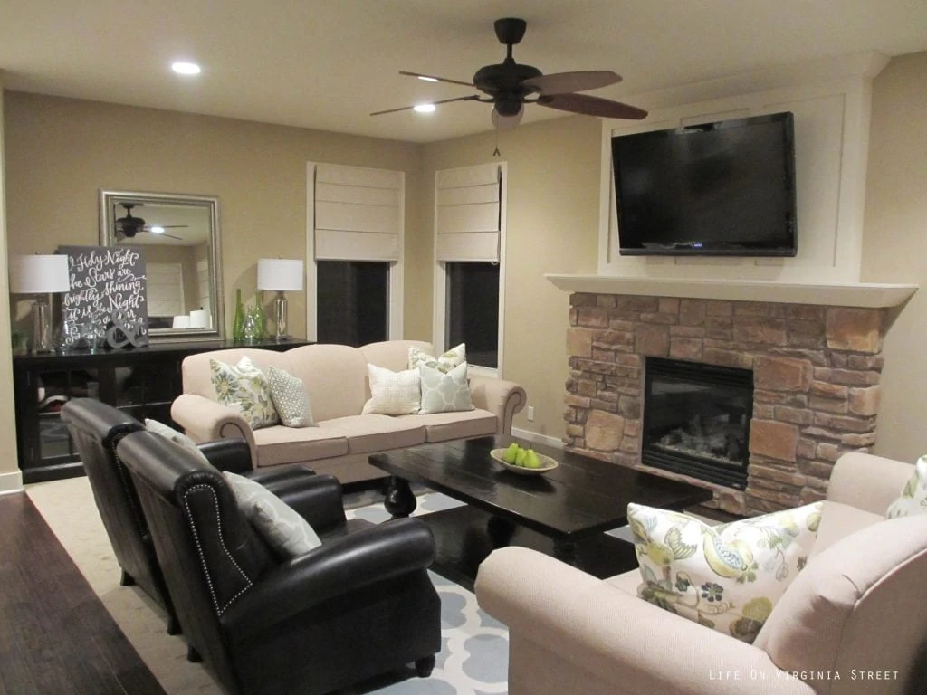Living Room before with dark cream walls, and stone fireplace.