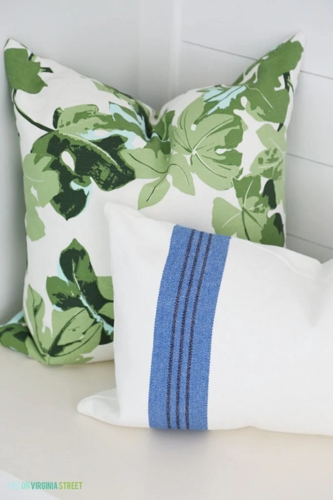 Blue and Green Mud Room Throw Pillows via Life On Virginia Street's Blue & White Summer Home Tour. I love this green fig leaf pillow paired with a blue and white striped lumbar pillow!