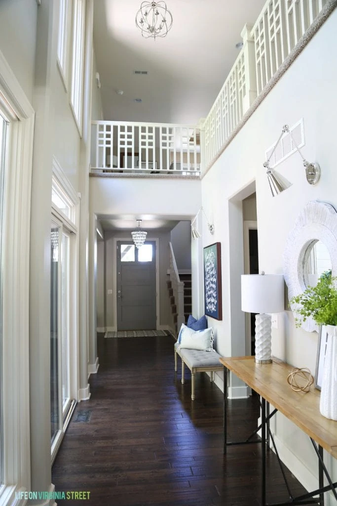 Entryway with Swing Arm Sconces above the mirror and picture.