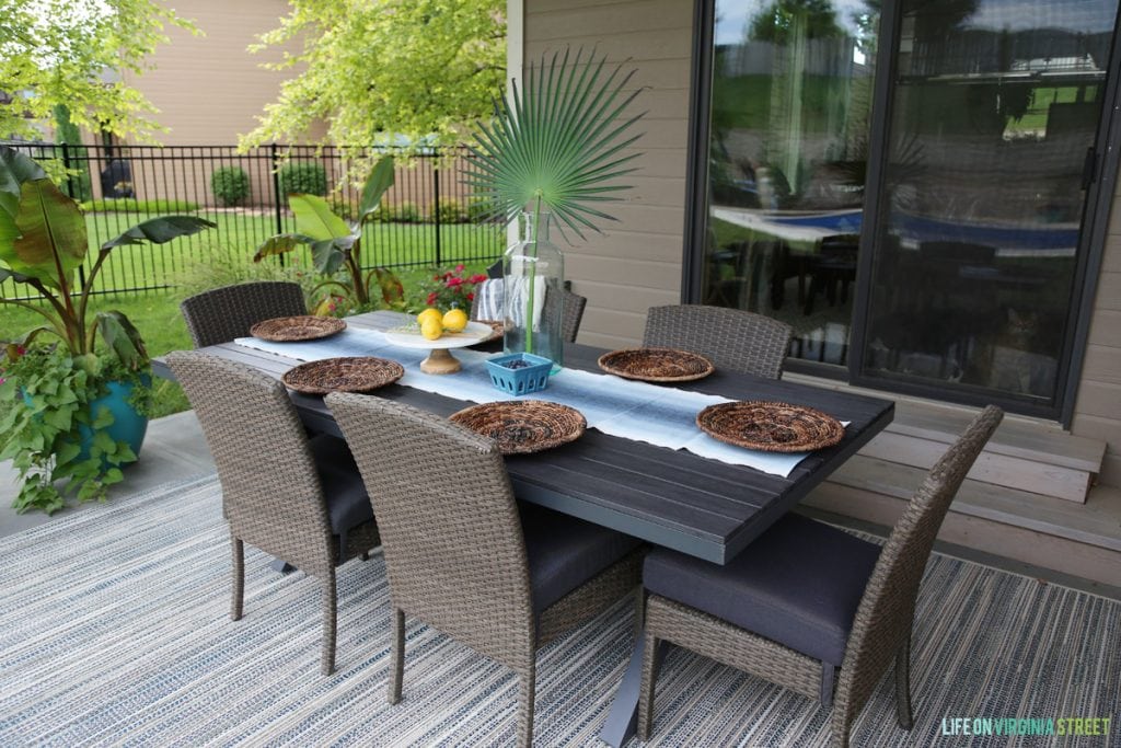 Patio with Rattan Furniture and Wood Table via Life On Virginia Street