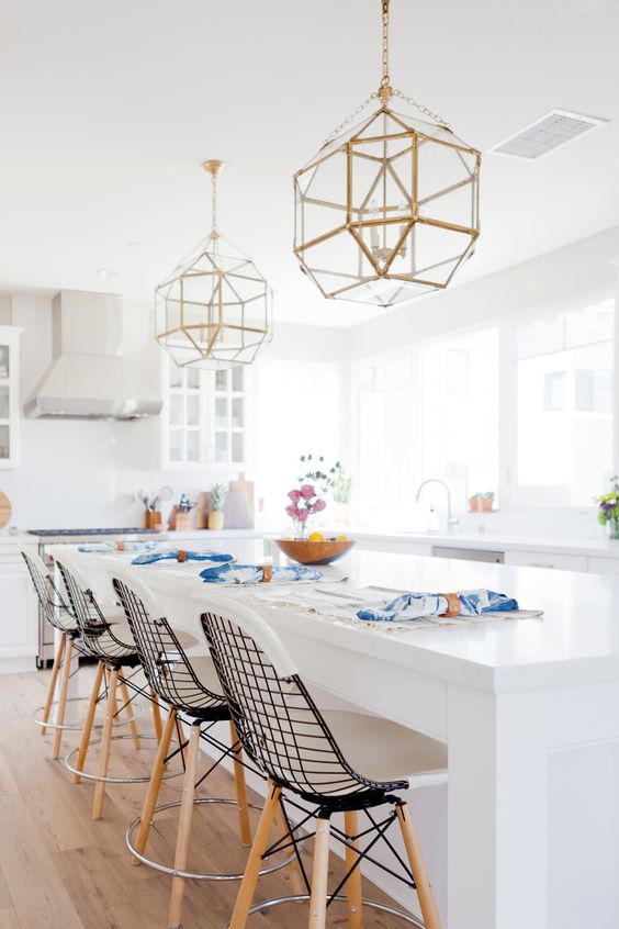Large pendant lighting over a white kitchen island.