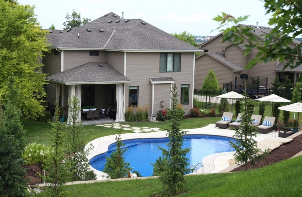 Backyard Pool with chairs around the pool.