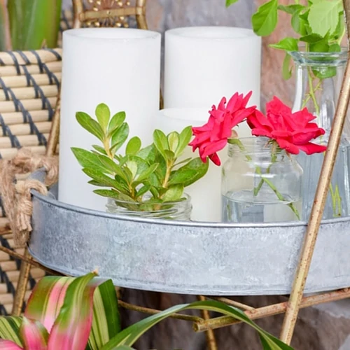 Plants and flowers in a galvanized outdoor tray.