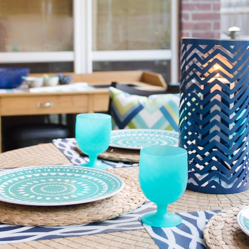A table with light blue glasses s set.
