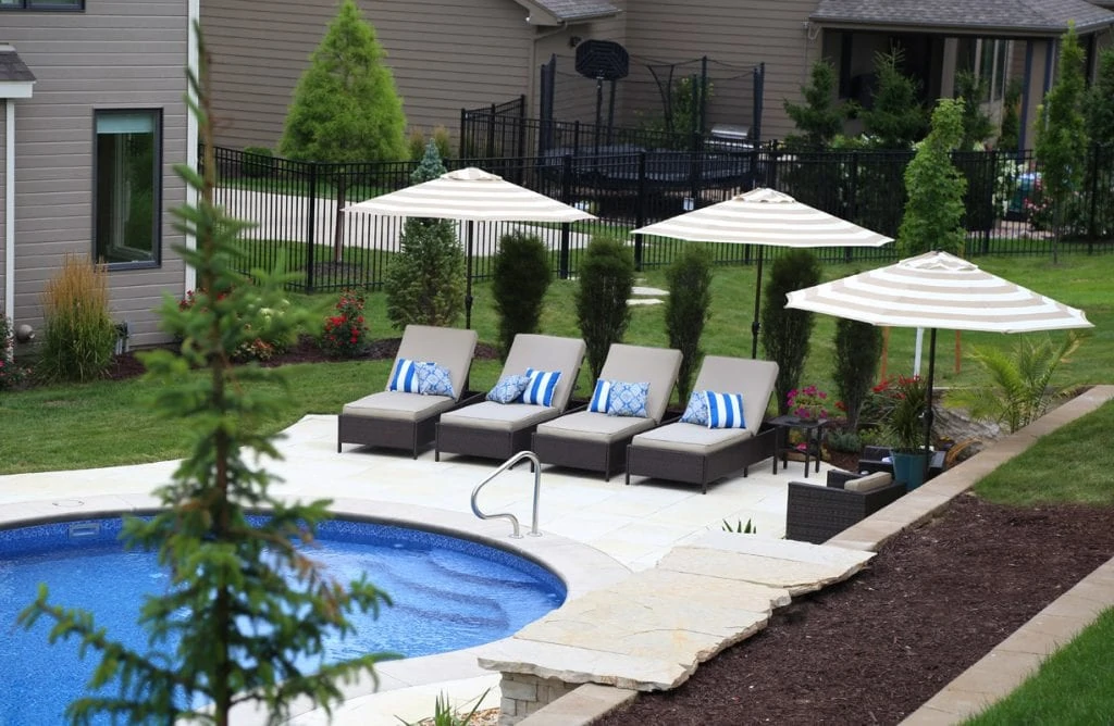 Pool Deck with Lounge Chairs and blue striped pillows on the chairs.