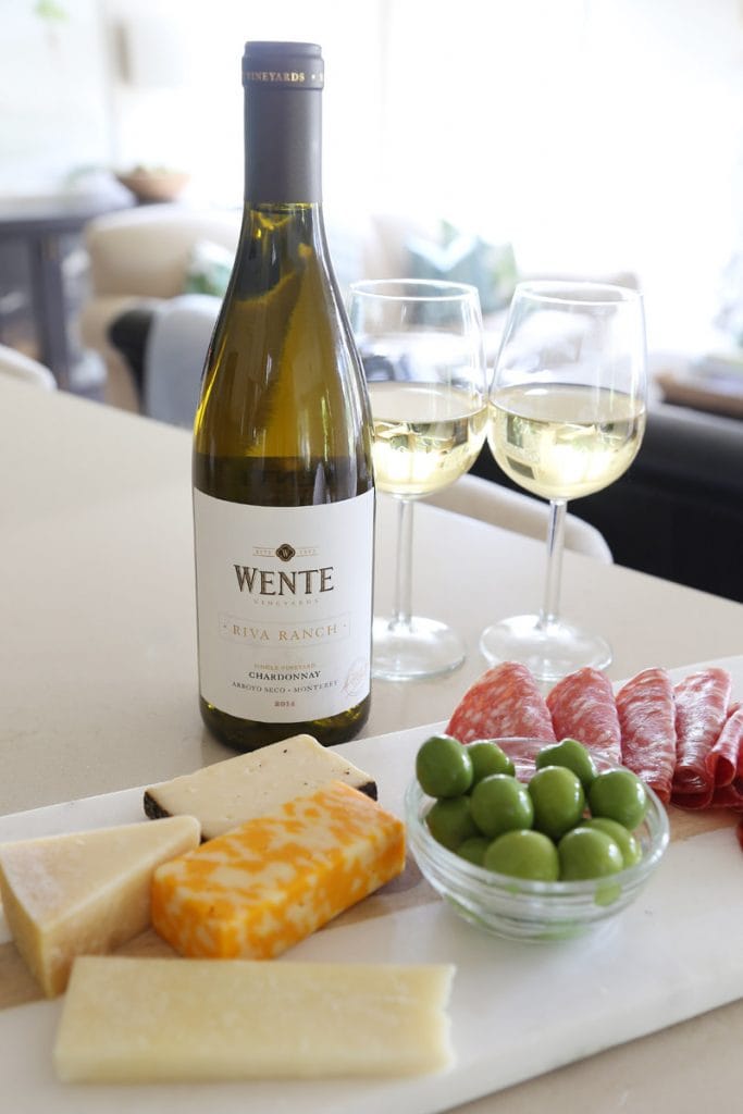 Wente Chardonnay, cheese, and meat on the table.