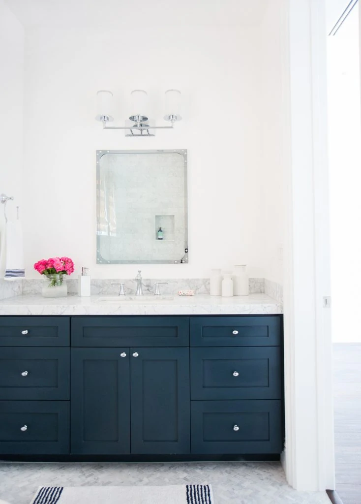 White and marble bathroom with Hale Navy cabinets via Studio McGee - Image via Tessa Neustadt
