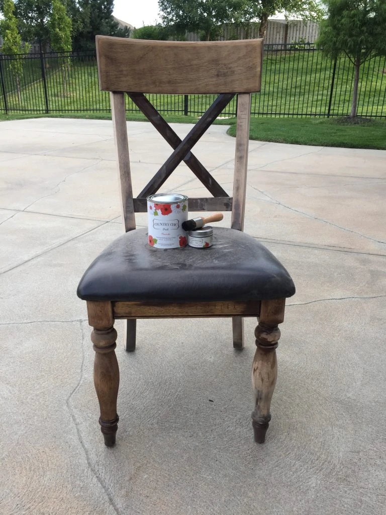 Sanded wood chair with stain can on the seat of the chair.
