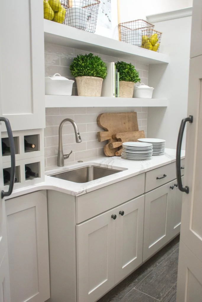 Walk-in Pantry with White and Gray Cabinets and Sink. Image via Mandy McGregor Photography.