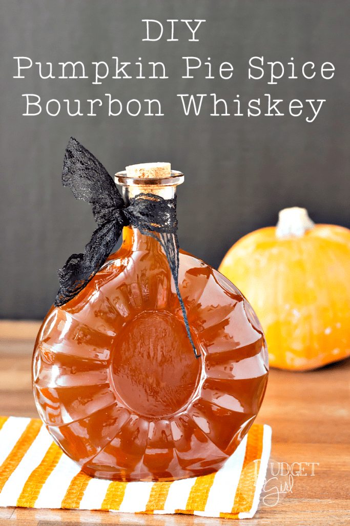 Pumpkin pie spice bourbon whiskey in a whiskey bottle with a black bow around it.