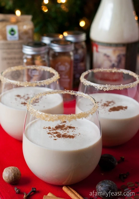 Eggnog in a clear glass with spiced rim.