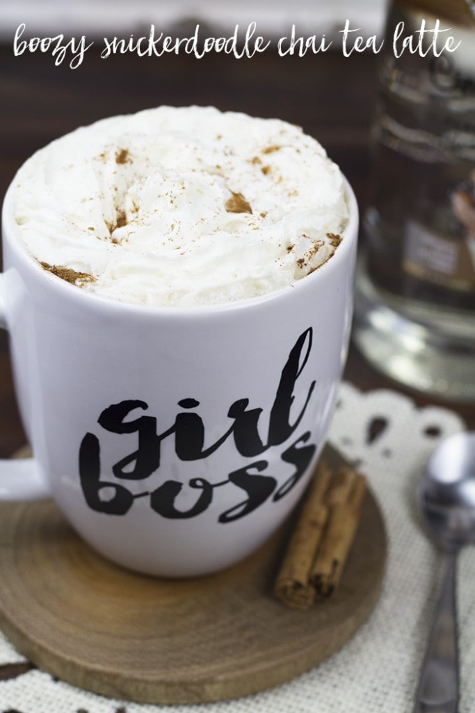 Snickerdoodle chai tea latte inside a white coffee cup with the words girl boss written in black on it.