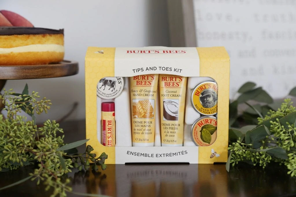 Burts Bees small sample gift box on the table beside pastry and greenery.