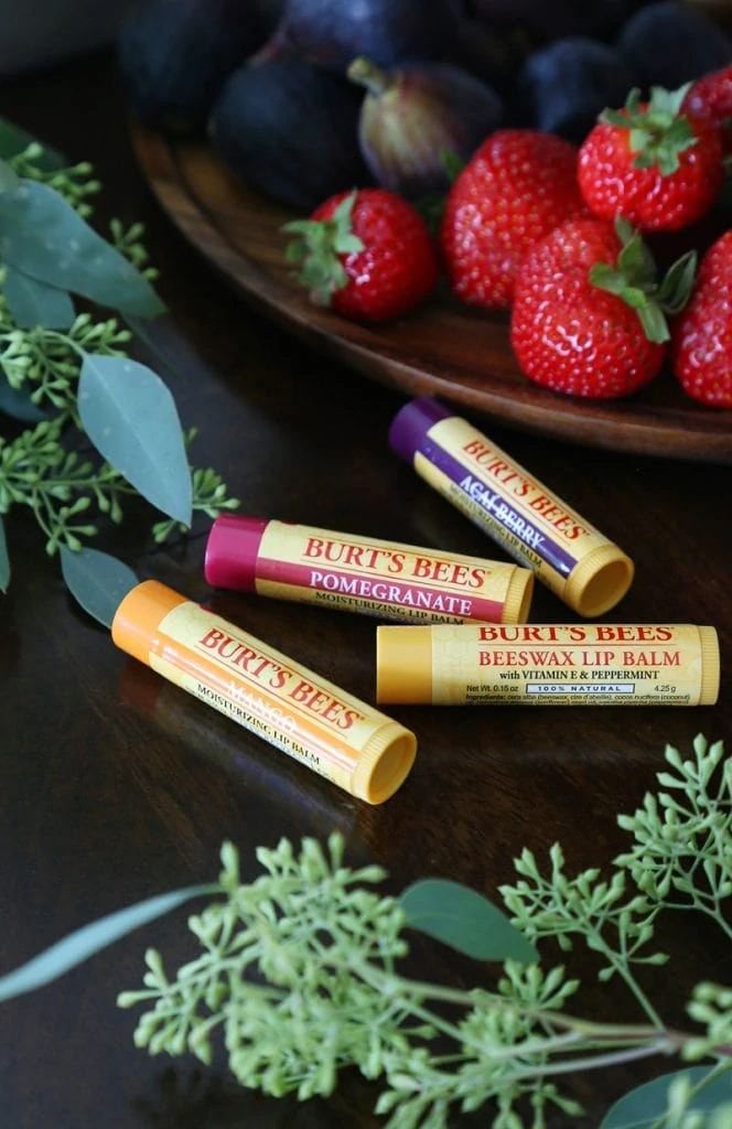 Lip balm by Burts Bees on the table beside the fruit.