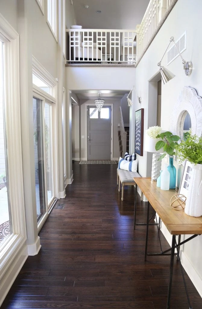 fall-entryway-with-dark-hardwood-floors-and-blue-and-green-accents-via-life-on-virginia-street