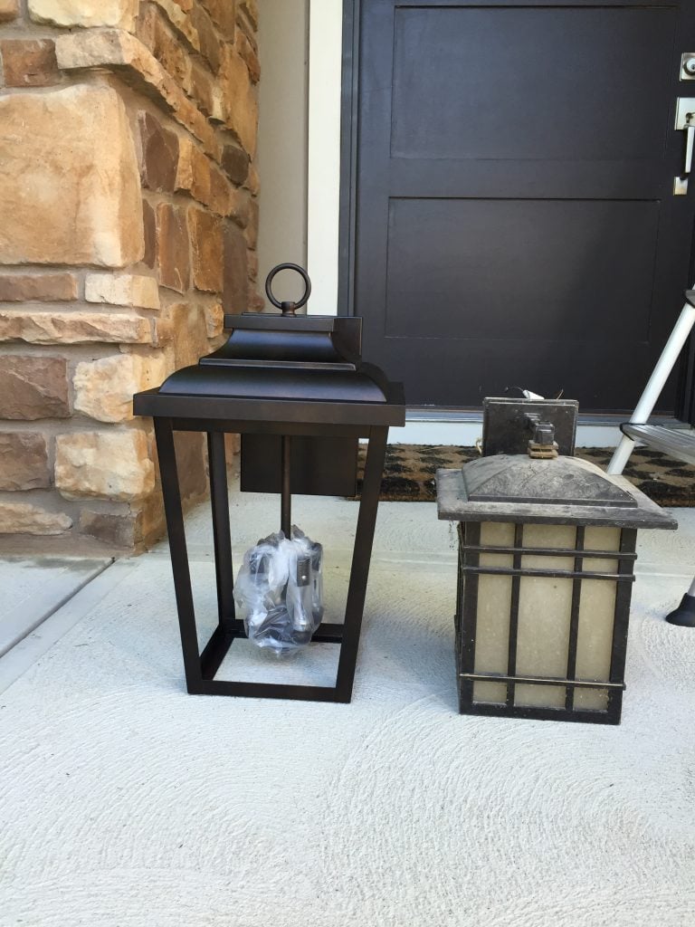 The new light fixture on the porch beside the old light fixture.