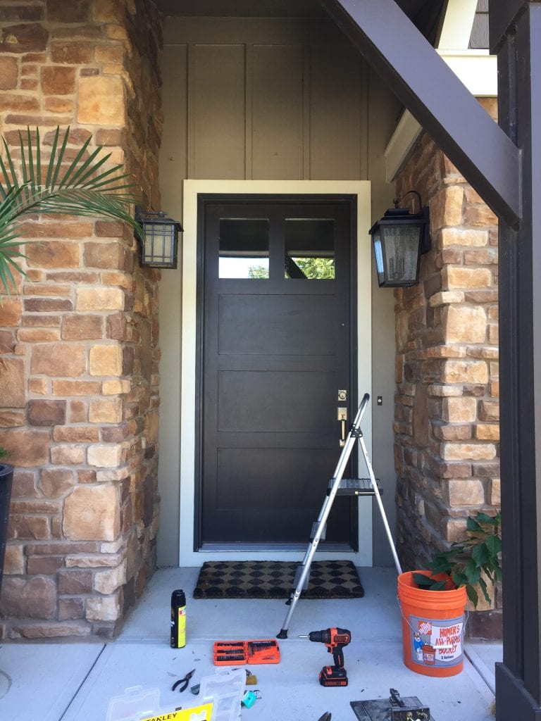 Our front porch refresh with new lights and a stepladder and tools.