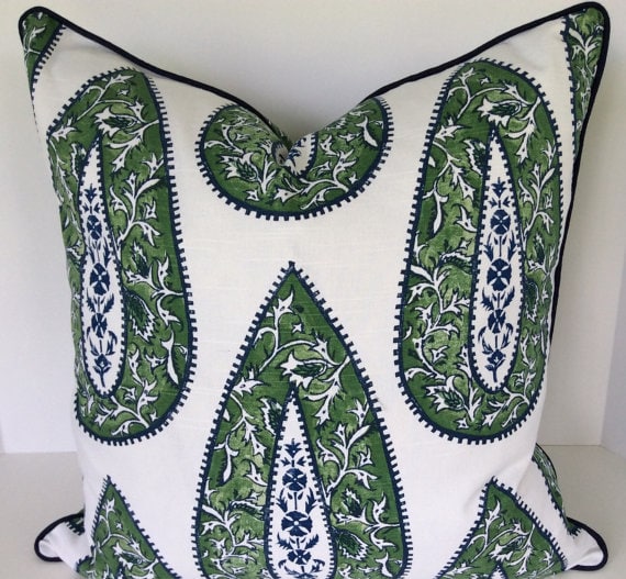 A gren, white and blue patterned pillow.