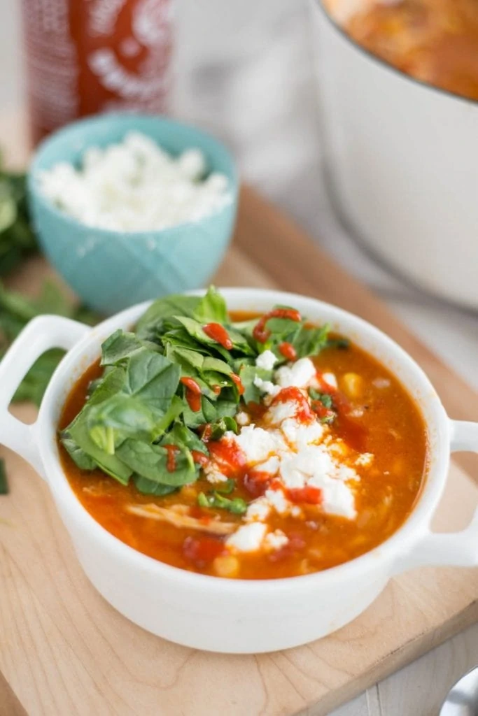 Chicken chili soup with spinach on top and feta.