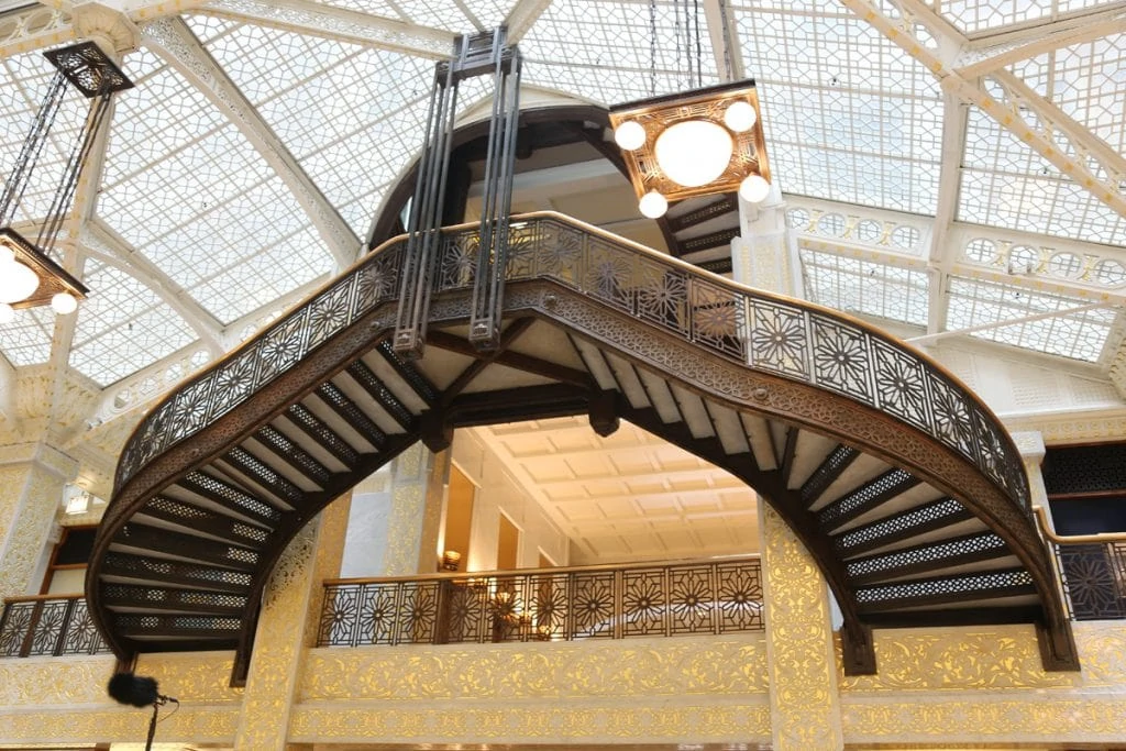 The ornate suspended staircase, with a glass ceiling.