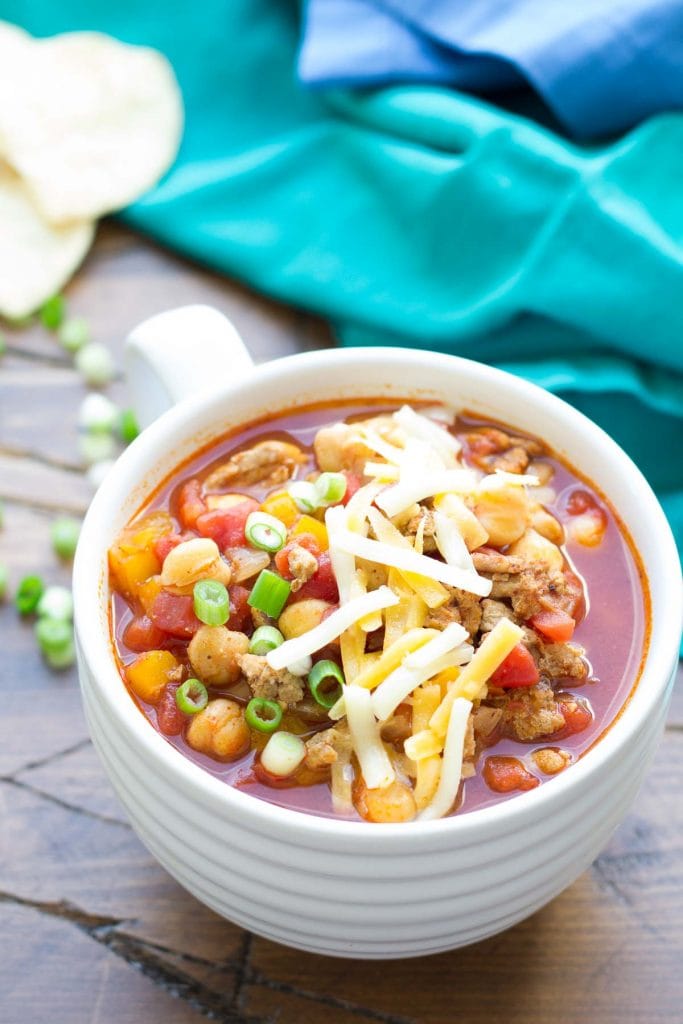 Turkey chickpea chili in a white mug on the table.