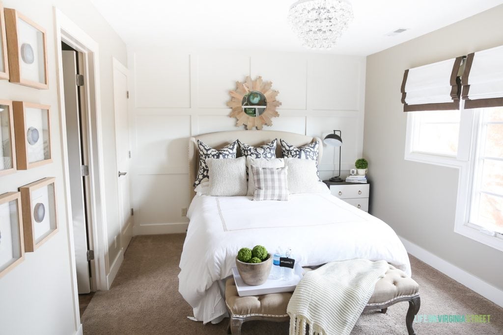 Guest bedroom with neutral bedding and green accents. Great tips on how to prepare your guest bedroom for the holidays!