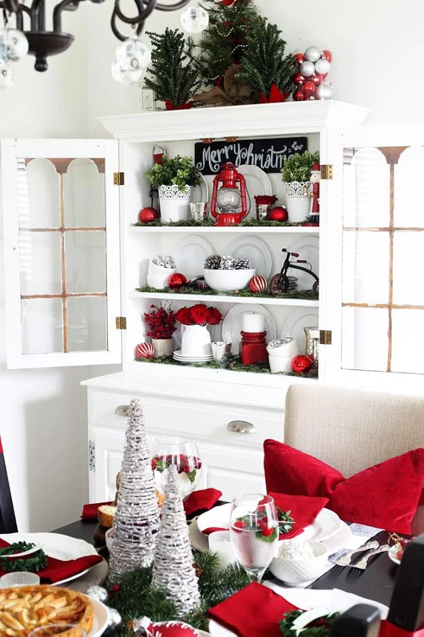 Open shelves with red and white decorations on it.